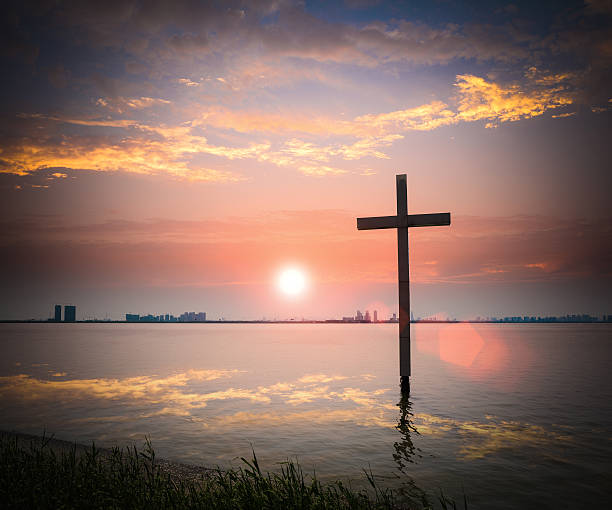 istock christian cross in the lake at dusk 179210861