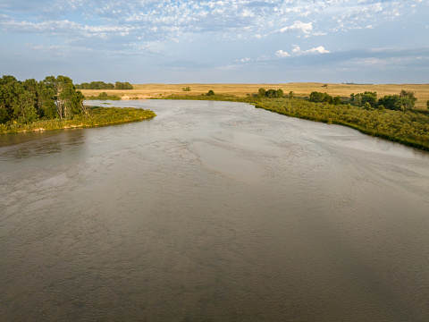 sandy, wide and shallow prairie river - Dismal River meandering through Nebraska Sandhills at Nebraska National Forest, aerial view of late summer scenery