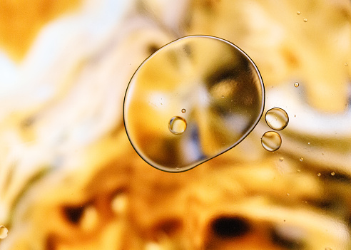 Abstract oil and water bubble on yellow and gold background