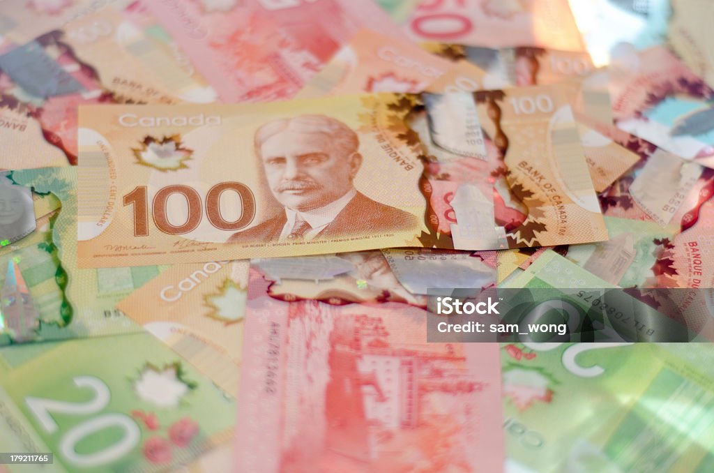 Pile of colorful Canadian money A pile of Canadian $100 (hundred,) $50 (fifty,) and $20 (twenty) bills. Canada Stock Photo