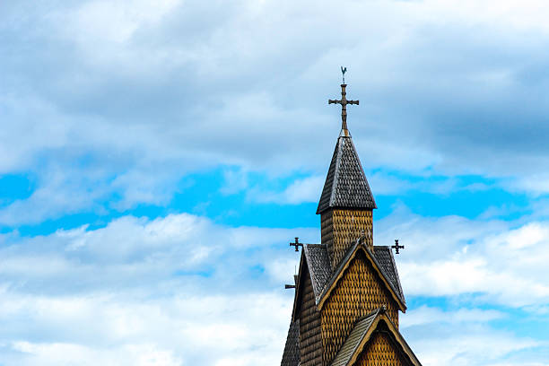 Stave Church Detail in the Sky The top of the famous stave church in Heddal with clouds in the sky. heddal stock pictures, royalty-free photos & images