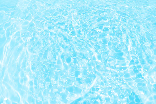 istock Defocus blurred transparent blue colored clear calm water surface texture with splashes and bubbles. Trendy abstract nature background. Water waves in sunlight with copy space. Blue watercolor shining 1792119699