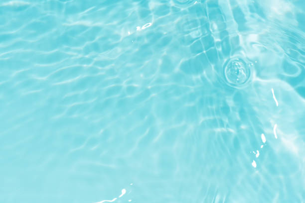 istock Defocus blurred transparent blue colored clear calm water surface texture with splashes and bubbles. Trendy abstract nature background. Water waves in sunlight with copy space. Blue watercolor shining 1792119768