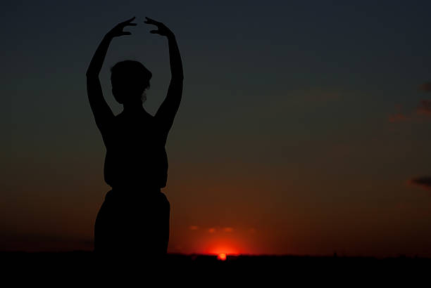 istock silhouette of a girl at sunset 179212345