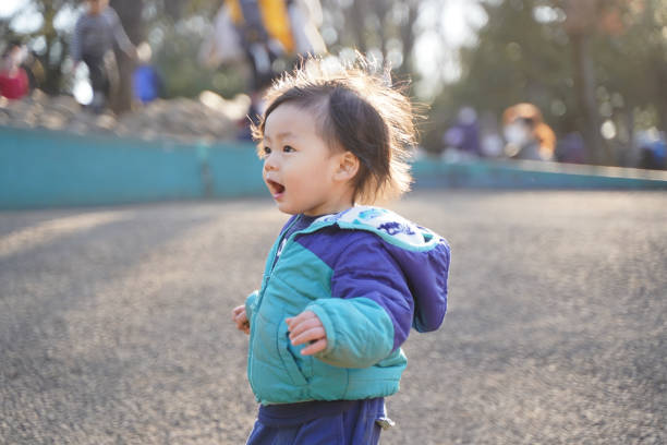 Little child playing happily in the park