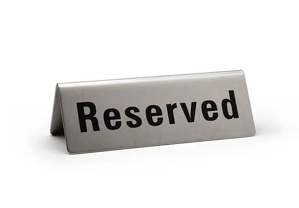 Reserved brushed metal steel signboard isolated white background.  Clipping path included.