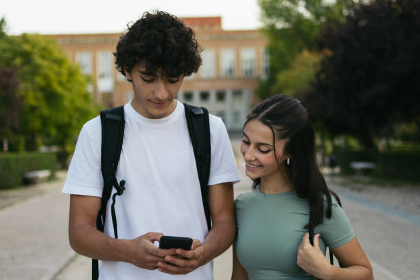 istock Cheerful young college students looking at smartphone. 1792138093