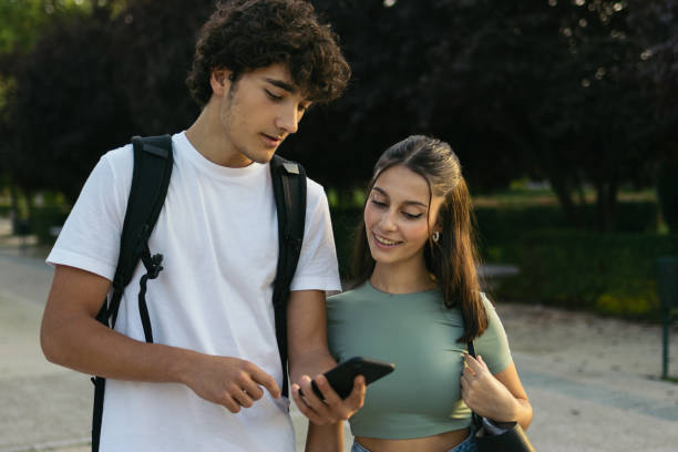 istock Cheerful young college students looking at smartphone. 1792142490