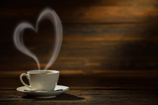 istock Coffee cup with heart shape smoke on vintage table 1792144714