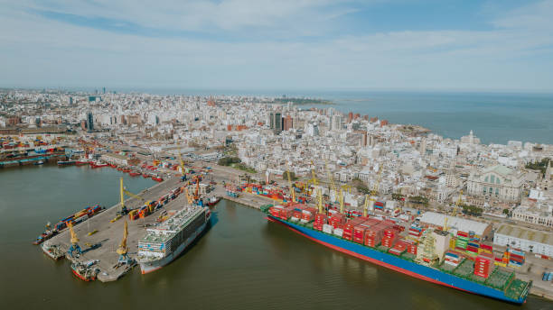 Container ship and city in the background with the sea