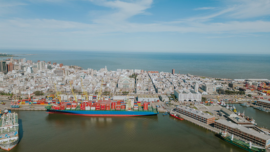 Ship with containers in a city surrounded by the sea
