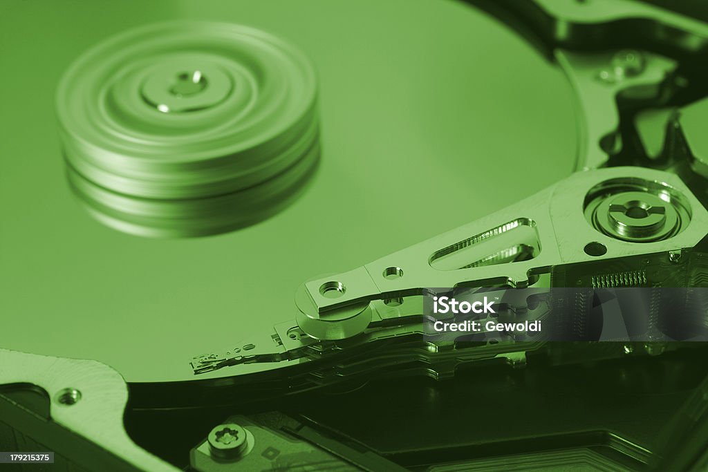 green hard disk drive green hard disk drive with moving head in close up. Close-up Stock Photo