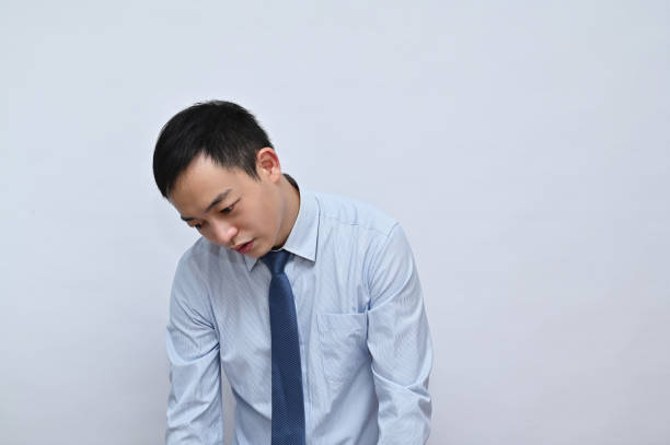 istock Tired office worker, Asian male face, white background. 1792164379