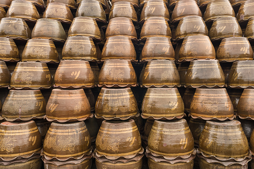 Stacks of completed Thai-style dragon jars, ornately designed, await shipment in a Ratchaburi province factory