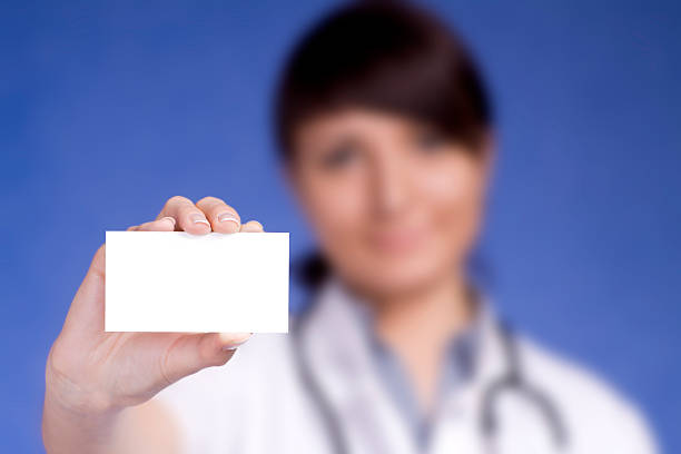 istock Women Doctor holding blank card 179217963