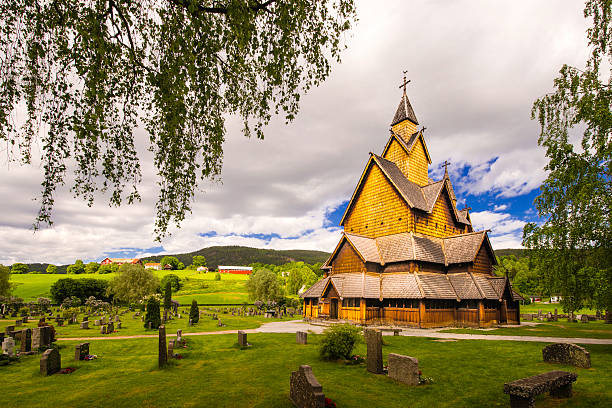 Heddal Yard and Stave Church A view of the church in Heddal, his yard and cementary. heddal stock pictures, royalty-free photos & images