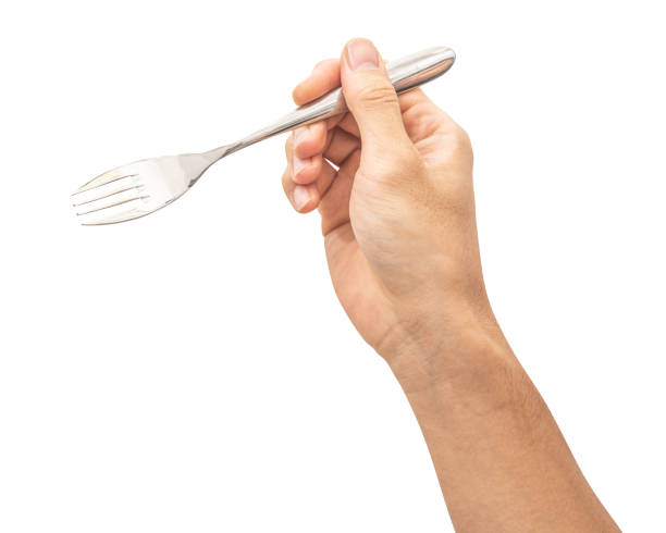 istock isolated of a man's hand holding a silver steel fork. 1792184804