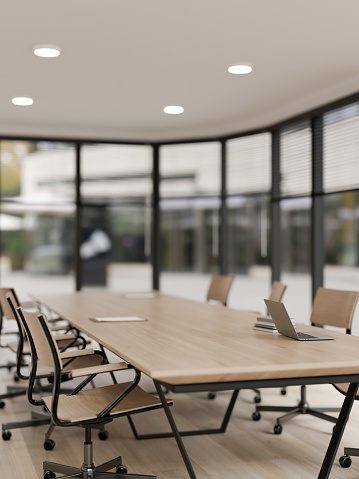 A modern minimalist meeting room, a laptop on a wooden meeting table in a modern spacious meeting room. place of work. 3d render, 3d illustration