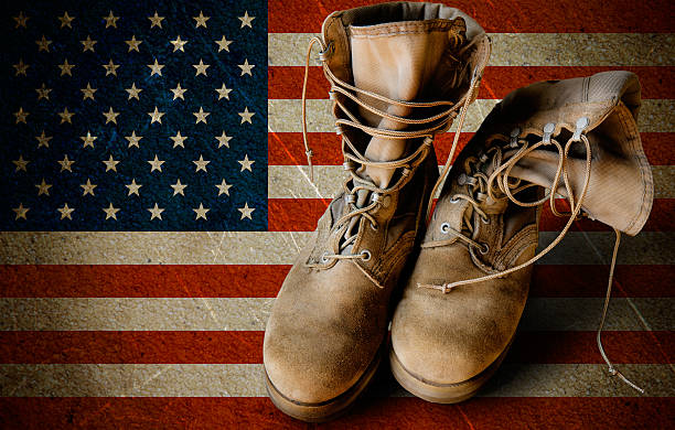 Army boots on sandy flag background Grunge US Army boots on sandy american flag background collage military deployment photos stock pictures, royalty-free photos & images