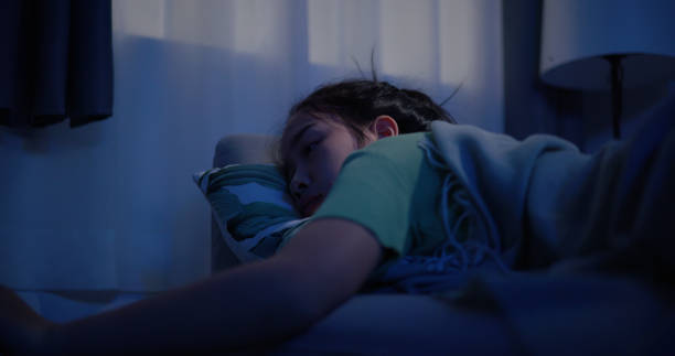 istock Young Asian female sleeping peacefully in her bedroom at night 1792205101