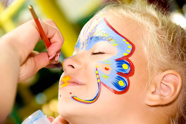 Face Painting Beautiful girl with blue eyes with painted butterfly on her face carnival children stock pictures, royalty-free photos & images