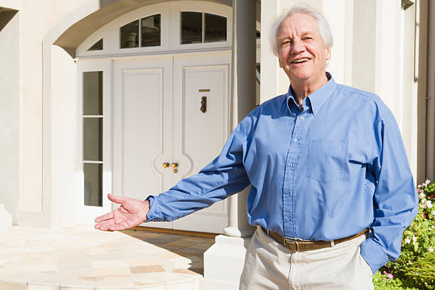 istock Senior man standing outside house 179220851
