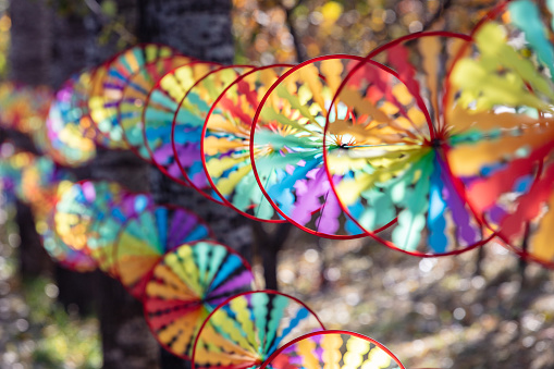 Colorful windmills made with traditional Chinese craftsmanship rotate in the wind