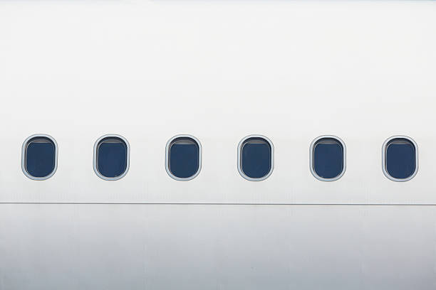 Windows of the airplane in white Windows of the white airplane - copy space fuselage stock pictures, royalty-free photos & images