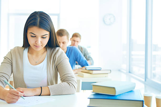istock Students at desks checking off answers 179223157