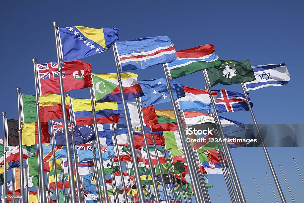 Flags of countries around the world Flags of all nations of the world are flying in blue sunny sky National Flag Stock Photo