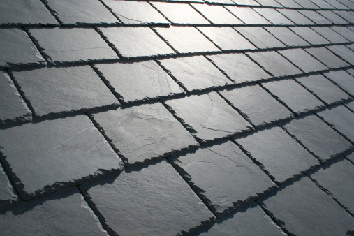A beautiful slate roof with tiles shining in the sun shine