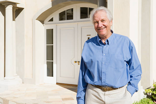 istock Senior man standing outside house 179223932