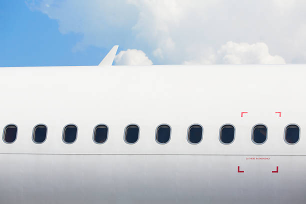 Windows of the airplane Windows of the white airplane - copy space emergency exit photos stock pictures, royalty-free photos & images