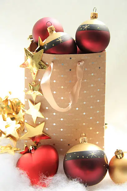 Red and golden christmas ornaments in a giftbag