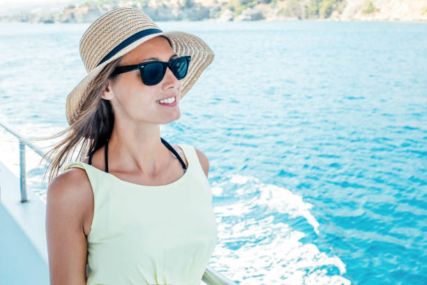 istock Smiling young woman standing on a boat during summer vacation 1792265430