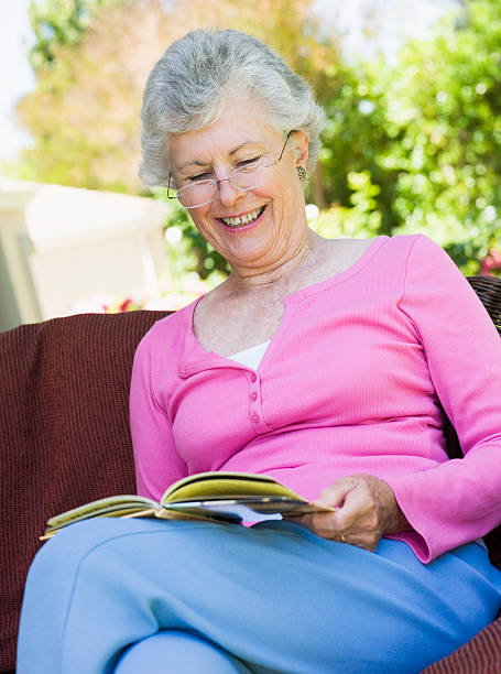 istock Senior woman reading book outside 179226994
