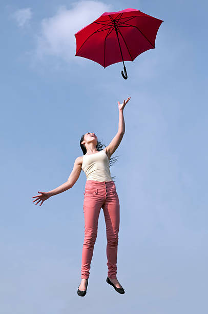 istock woman jumping with red umbrella 179227495