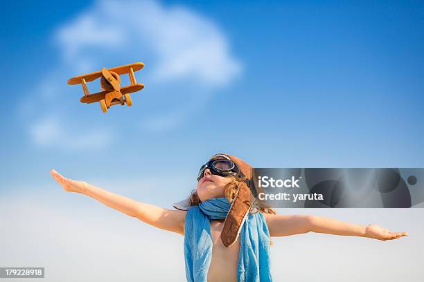 Kid Playing With Toy Airplane Under Clear Blue Sky Stock Photo - Download Image Now - Activity, Airplane, Baby - Human Age