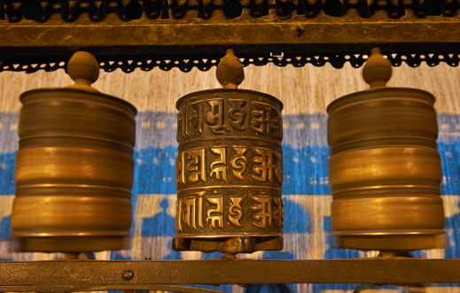 Buddhist prayer wheels in Swayambhunath. Swayambhunath is an ancient religious complex atop a hill in the Kathmandu Valley.