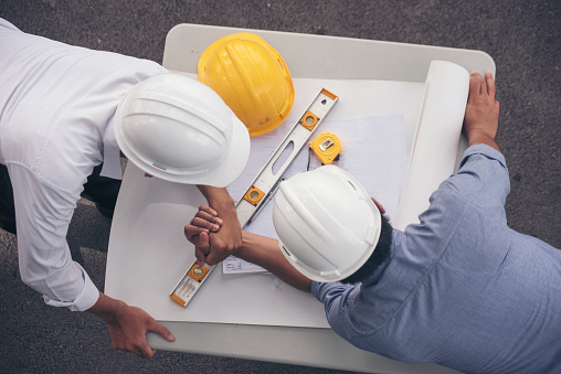 Group of multiracial people Teamwork meeting join hands Engineer Manager Foreman fist bump together. Close up diversity engineer people hands partner teams. Business connection team join partnership