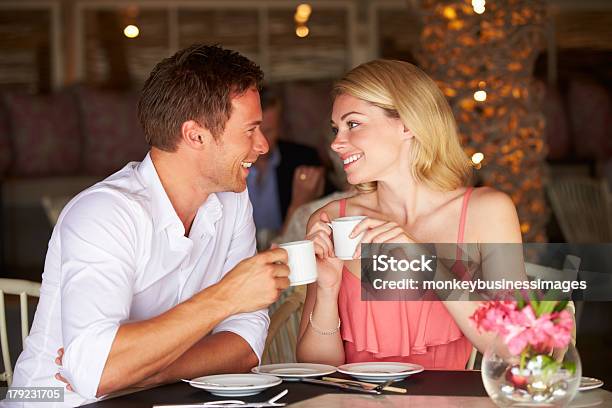 Couple Enjoying Cup Of Coffee In Restaurant Stock Photo - Download Image Now - 20-29 Years, Adult, Adults Only