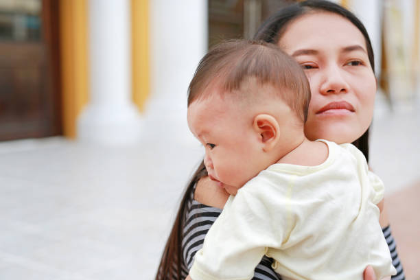 istock Asian mother carrying her infant. Close-up. 1792317400