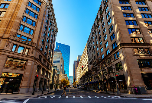 Boston, Massachusetts, USA - November 11, 2023: View down St. James Street from its intersection with Arlington Street in Boston's Back Bay neighborhood. In the background is the 200 Clarendon Street skyscraper, aka the John Hancock Tower.