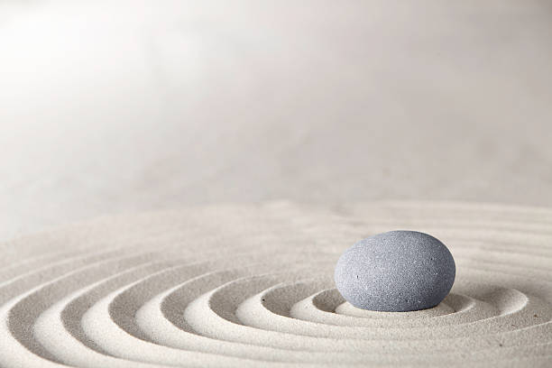 zen stone zen stone in Japanese sand garden concept for spirituality and purity buddhism stock pictures, royalty-free photos & images