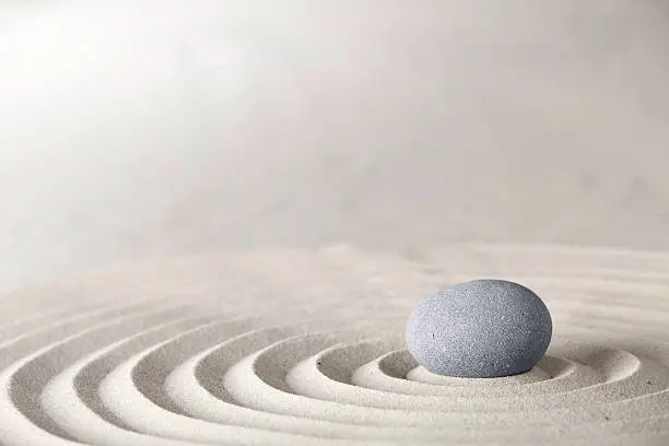 zen stone in Japanese sand garden concept for spirituality and purity