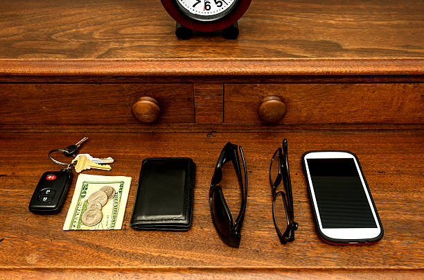 Items in a man's pockets neatly laid out on the dresser.