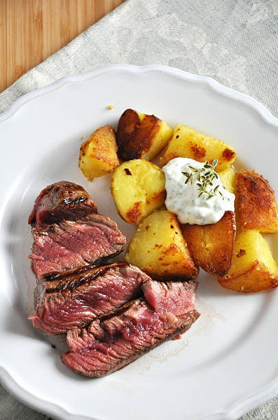 istock juicy steak with potato wedges 179233204