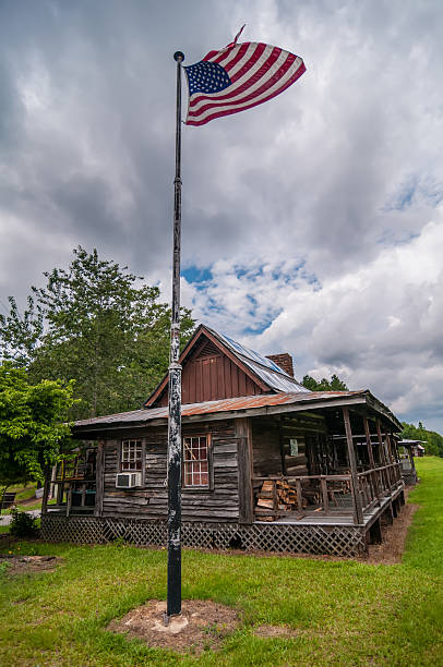 istock old log cabin and american flag 179233495