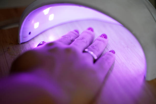 istock Woman drying her nails at home with UV lights 1792340585