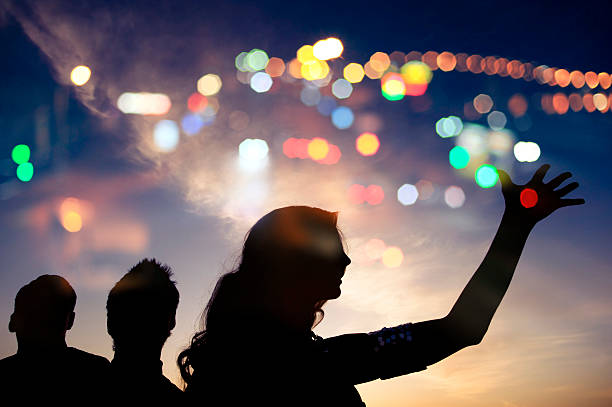 istock Evening walk, silhouette of three people with night lights. 179234547
